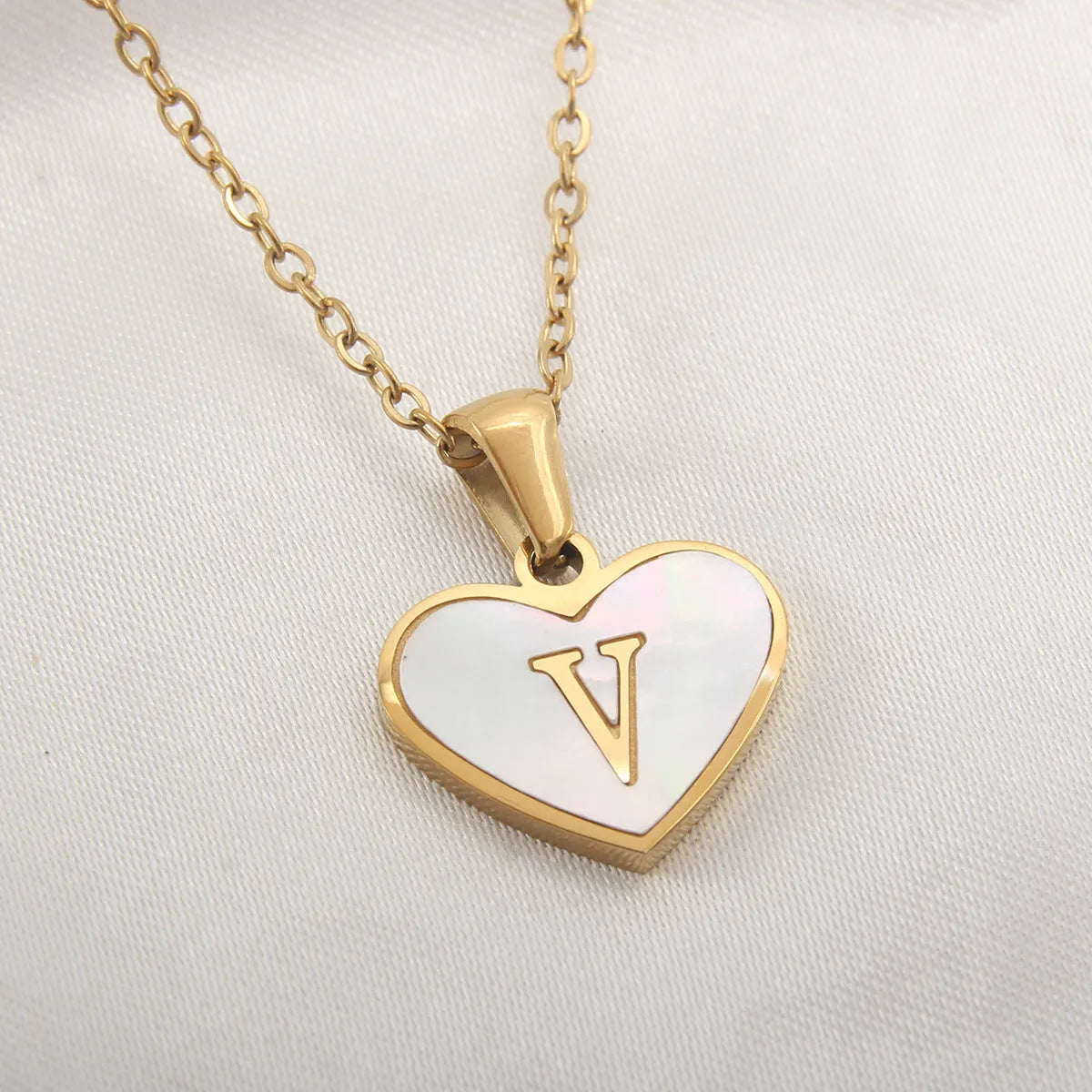 Gold heart necklace with white shell pendant and initial charm on 45cm adjustable chain