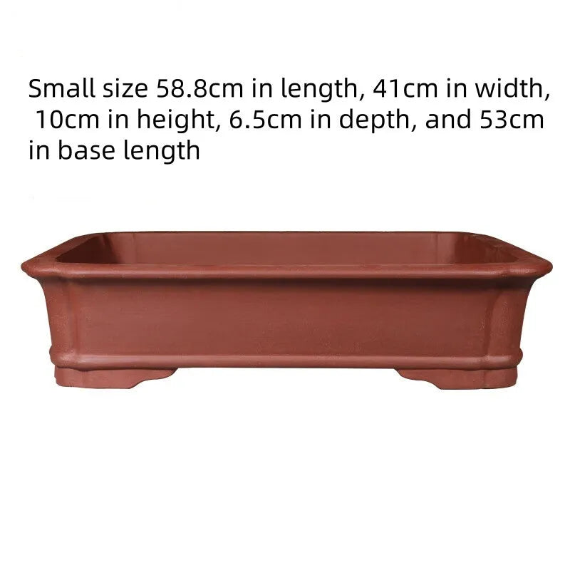 Large rectangular handmade purple clay bonsai flowerpot shown on a wooden surface.