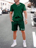 Sports style short-sleeved top and matching shorts set laid flat, showing thin polyester blend fabric.