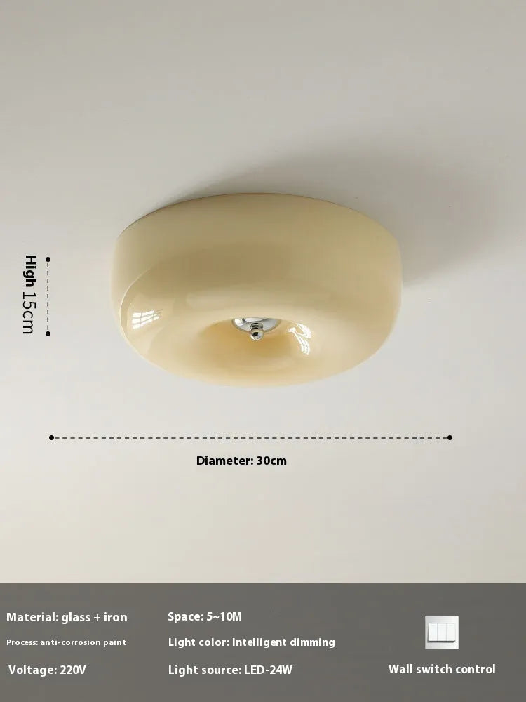 American-style antique finish ceiling lamp with cream coloured shade in bedroom setting