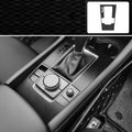 Car interior decorative film sticker kit showing carbon fibre pattern applied to centre console and dashboard