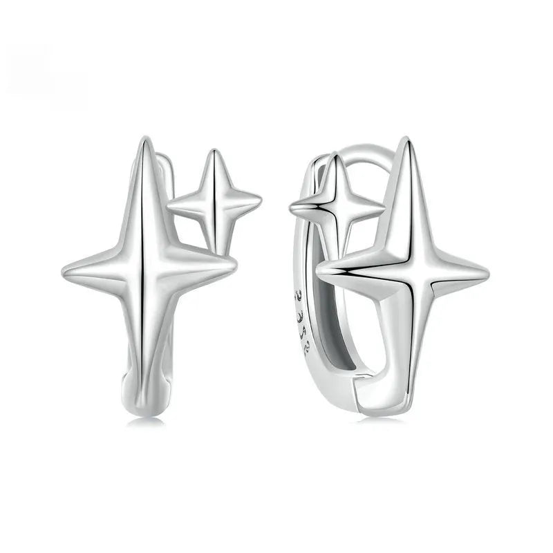 Minimalist sterling silver star-shaped clip-on earrings featuring a XINGX pattern and oxidised finish.
