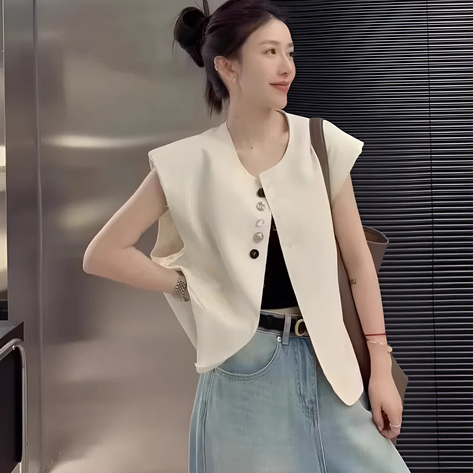 Women's polyester vest in milky white or black with pocket detail and loose fit