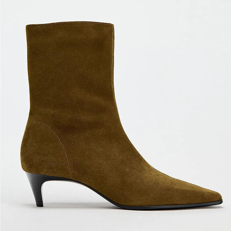 Brown women's square toe mid-calf boots with a side zipper and a low kitten heel on a wooden floor.