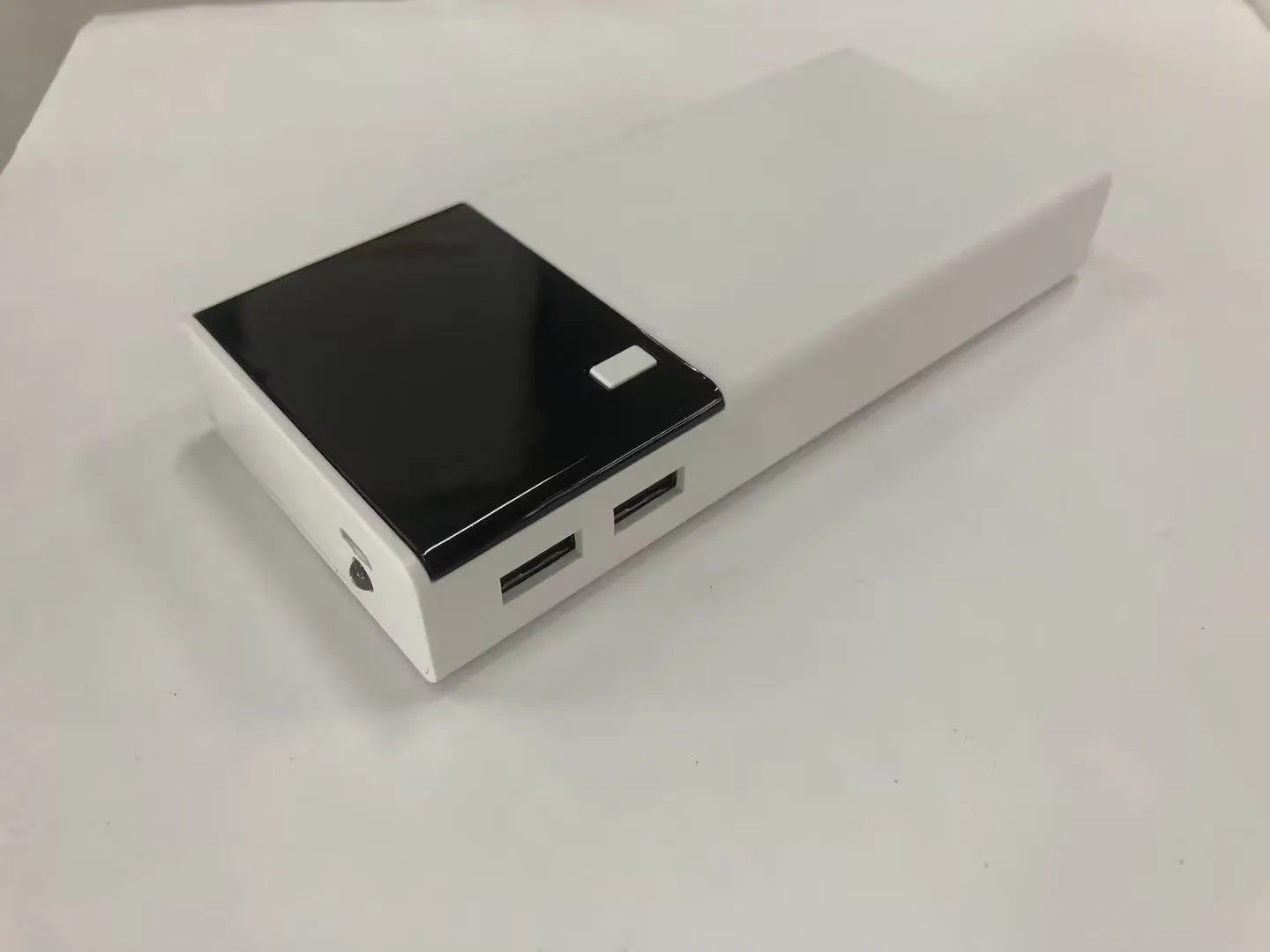Black rectangular 20000mAh portable power bank with a charging cable.