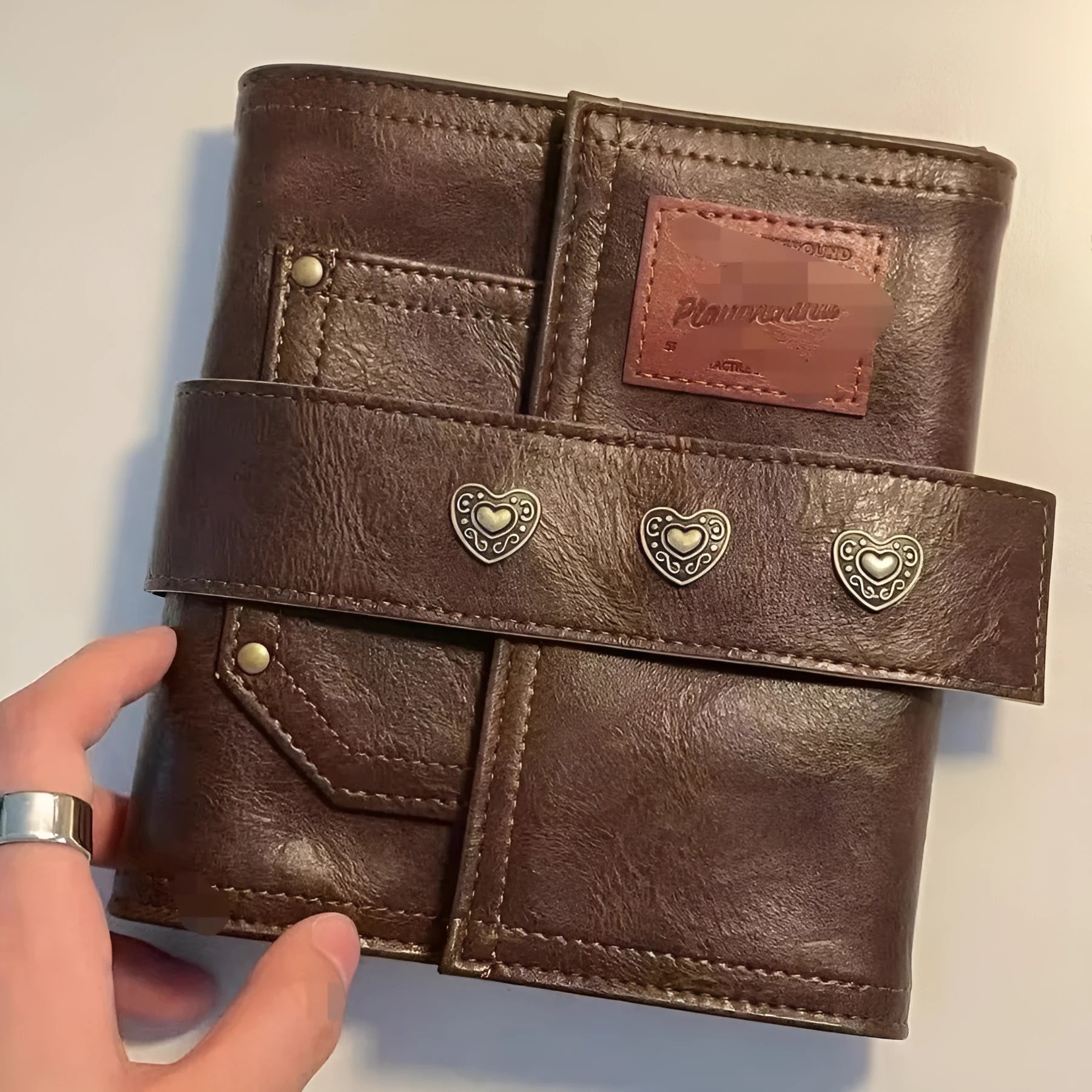 Brown retro leather-style A7 notebook with buckle closure and loose-leaf binding