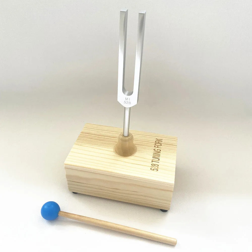 Aluminium alloy 432Hz tuning fork with speaker on kraft paper box background