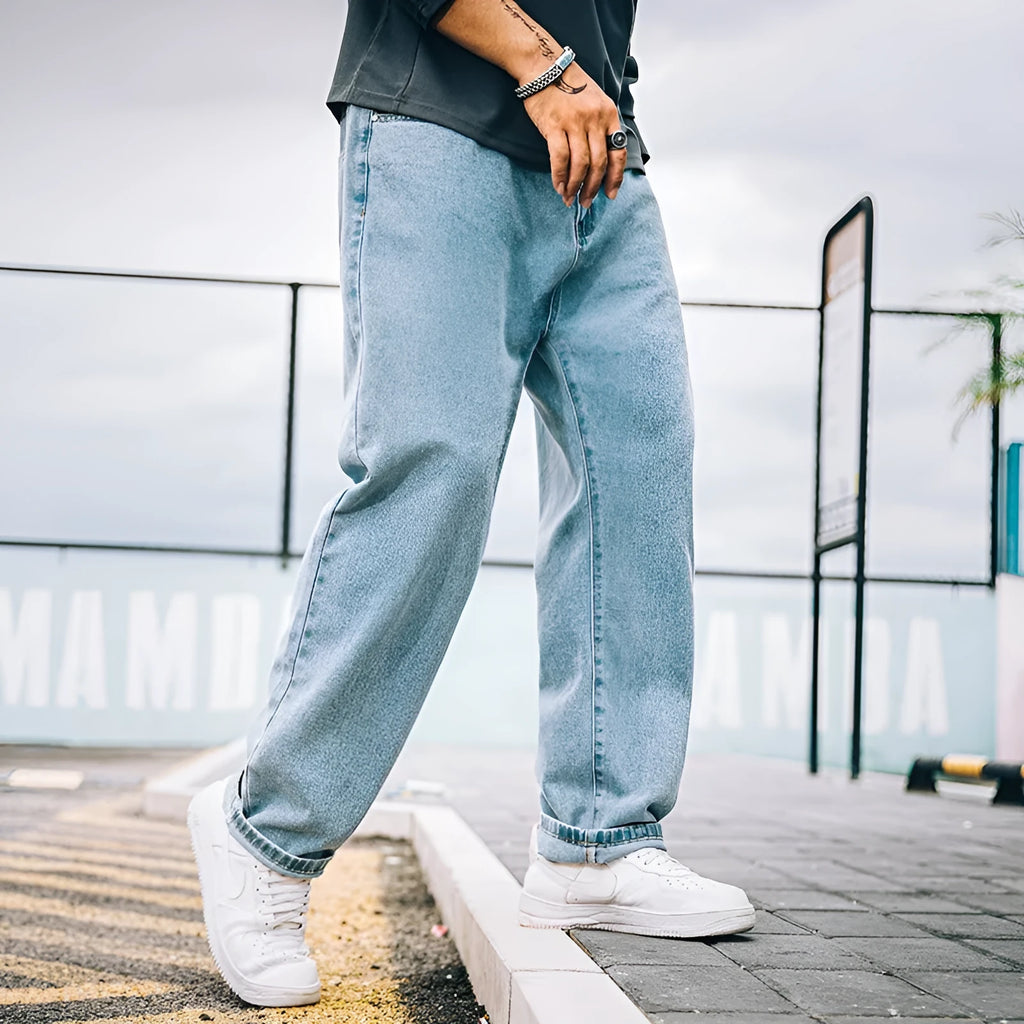 Men's loose straight jeans in cotton fabric showing mid waist fit and straight leg cut