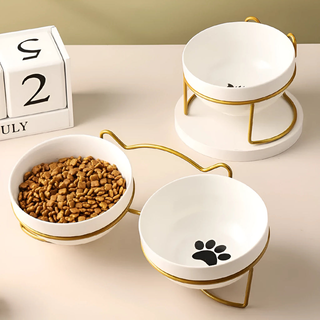White ceramic cat bowl with decorative pattern and black iron frame support