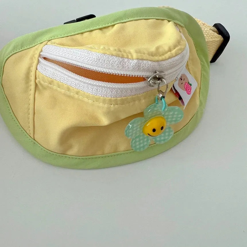 Powder blue messenger bag-style dog backpack for holding poop bags, shown with adjustable chest strap.
