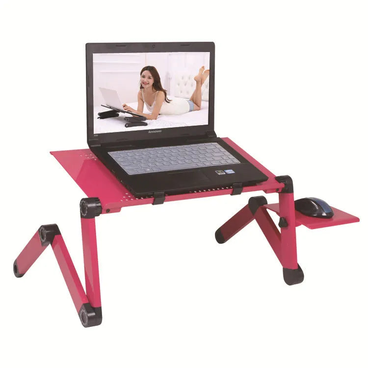 Black folding metal laptop desk with cooling holes on a sofa