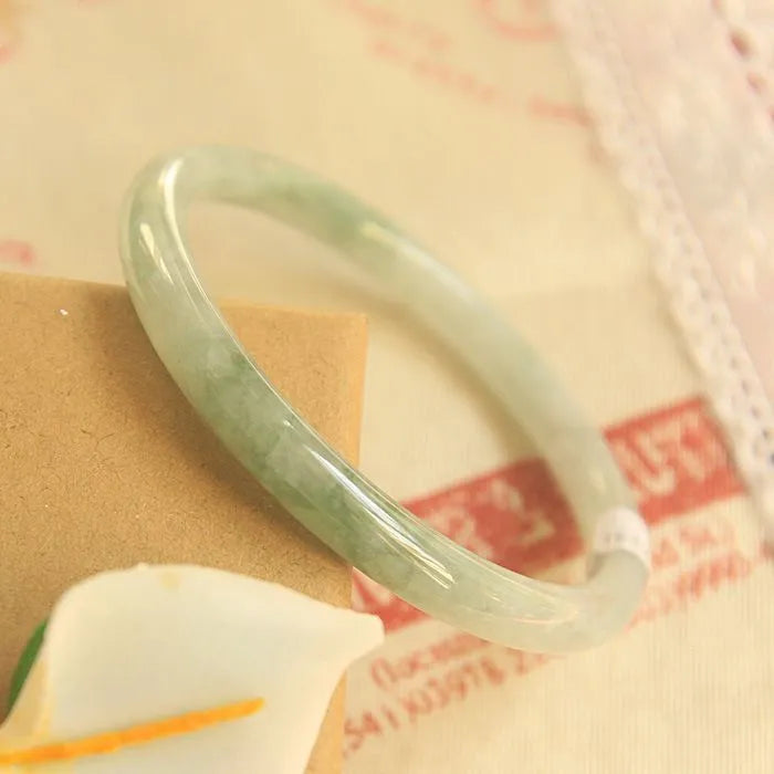 Green handmade jade waxy student bracelet with geometric beads in Chinese style, showing adjustable sizing options