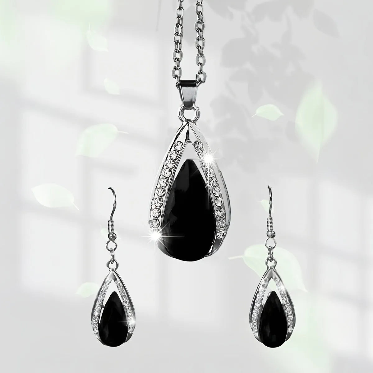 Black and red alloy water droplet pendant necklace and matching earrings jewellery suite.