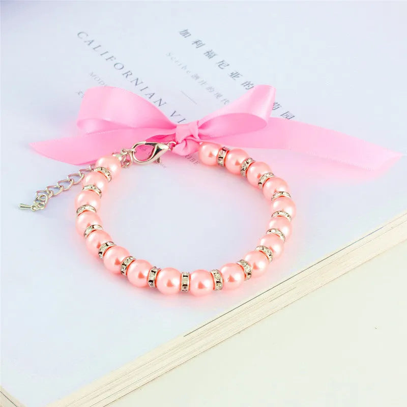 Adjustable pearl and rhinestone dog necklace on a soft ribbon in blue colour