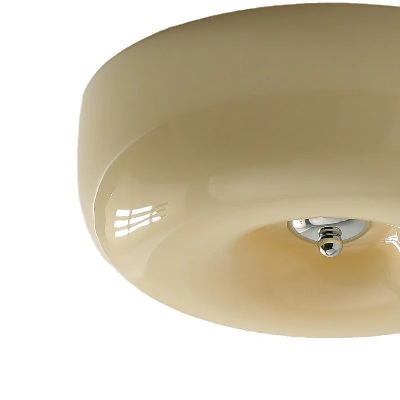American-style antique finish ceiling lamp with cream coloured shade in bedroom setting