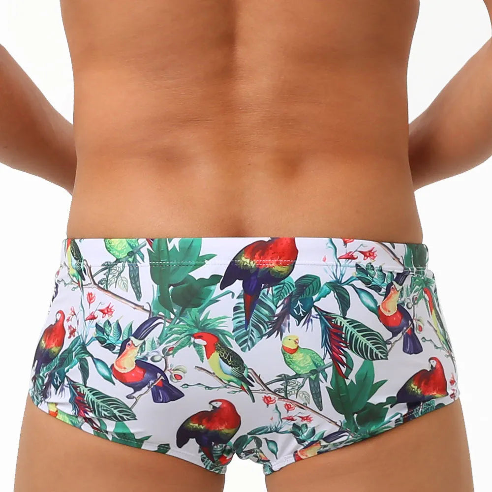 Men's floral bird print swimming trunks in nylon fabric, shown in small boxer style.
