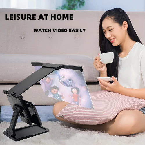 Black folding mobile phone screen amplifier with detachable holder showing 3-4x magnification