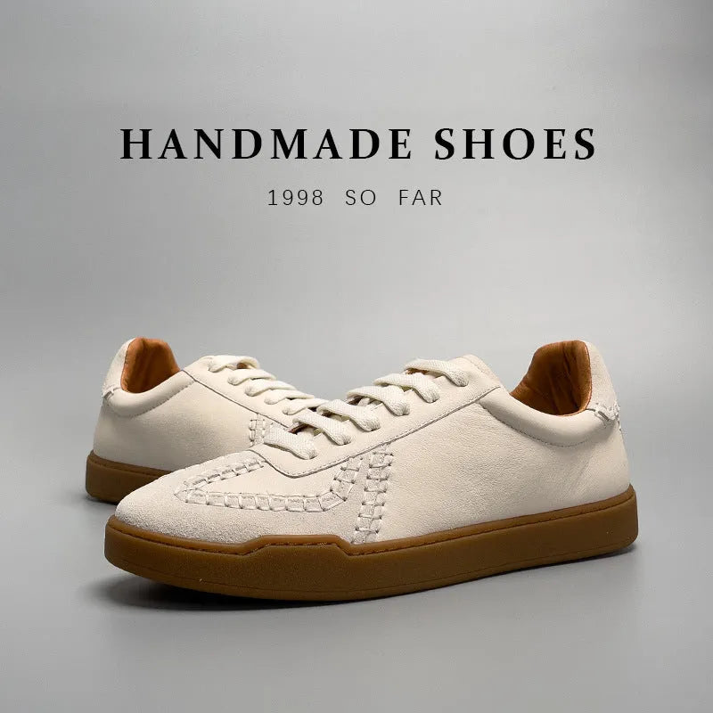 Men's beige genuine leather low-cut sneakers with white lace-up front and rubber sole on neutral background