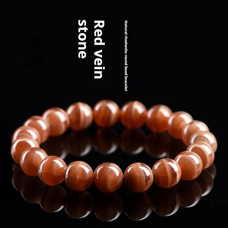 Natural Rhodochrosite round beads bracelet from Peru with geometric design and Ruyi elements