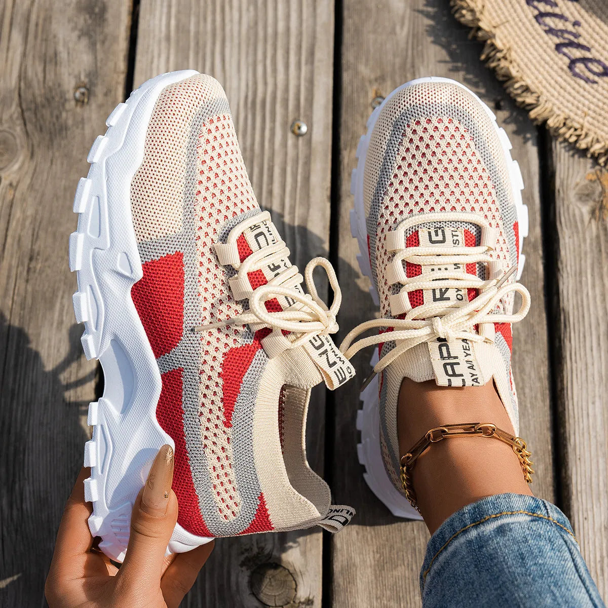 Women's Flyknit mesh lace-up sneakers in a selection of colours, showing round toe and flat rubber sole.