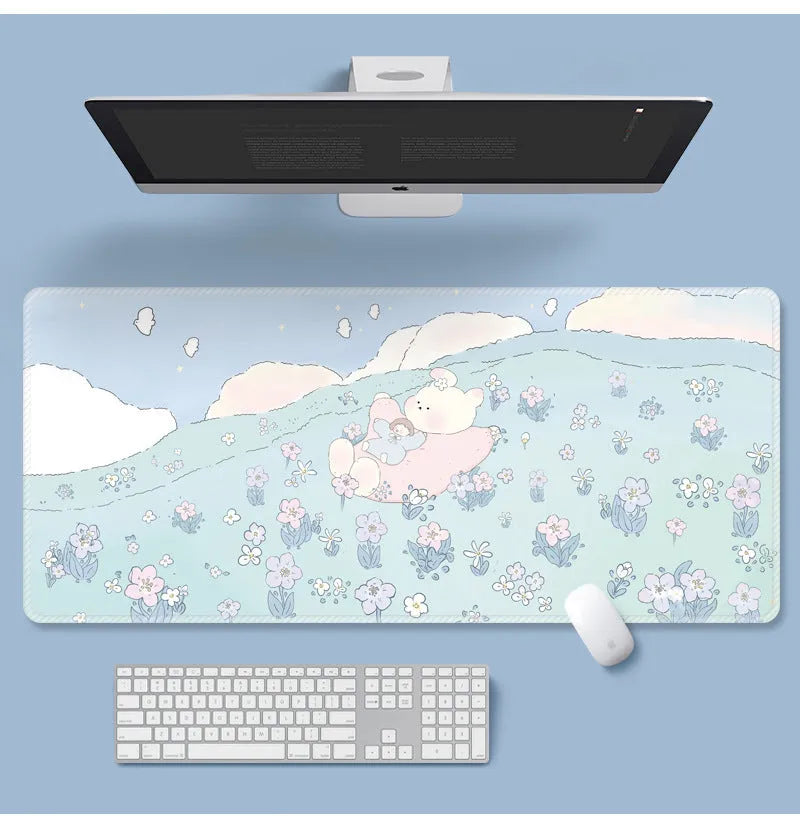 Large floral pattern mouse pad on a desk, showing non-slip rubber base and thin cloth surface.