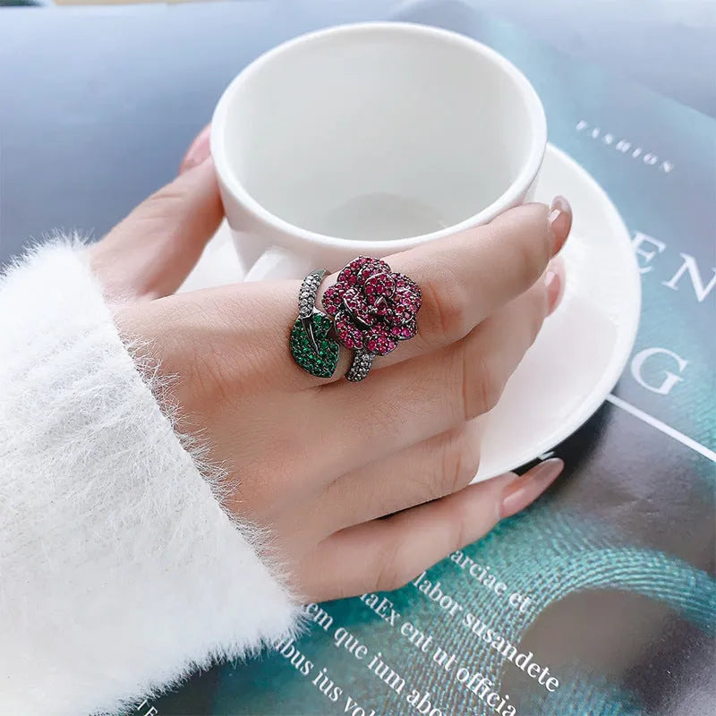 Gold-plated black gold ring with geometric shape and floral design featuring simulation red corundum elements
