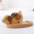 Solid beech wood mobile phone holder with decorative resin animal figure on wooden base