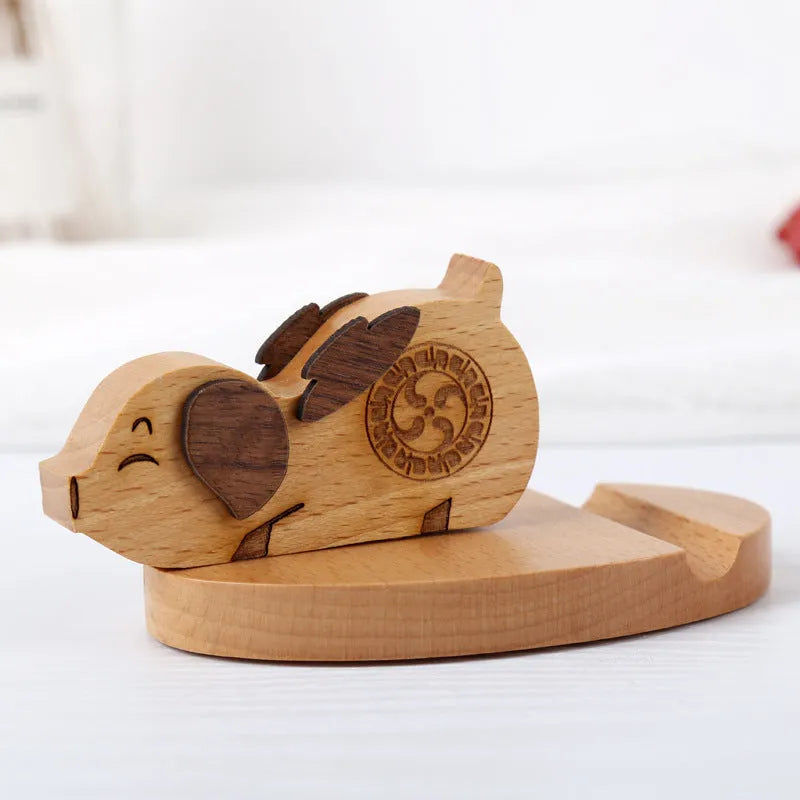 Solid beech wood mobile phone holder with decorative resin animal figure on wooden base