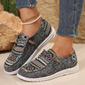Women's black flat slip-on shoes with round toe and rubber sole on a neutral background.