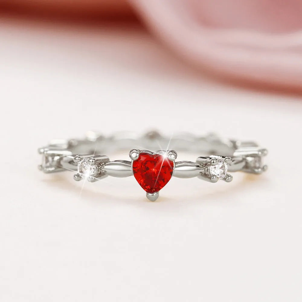 Gold or silver colour peach heart shaped ring with zircon stones on a copper band.