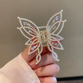 Butterfly hair barrettes in alloy with rhinestone or pearl styles measuring 6.7x6.2cm