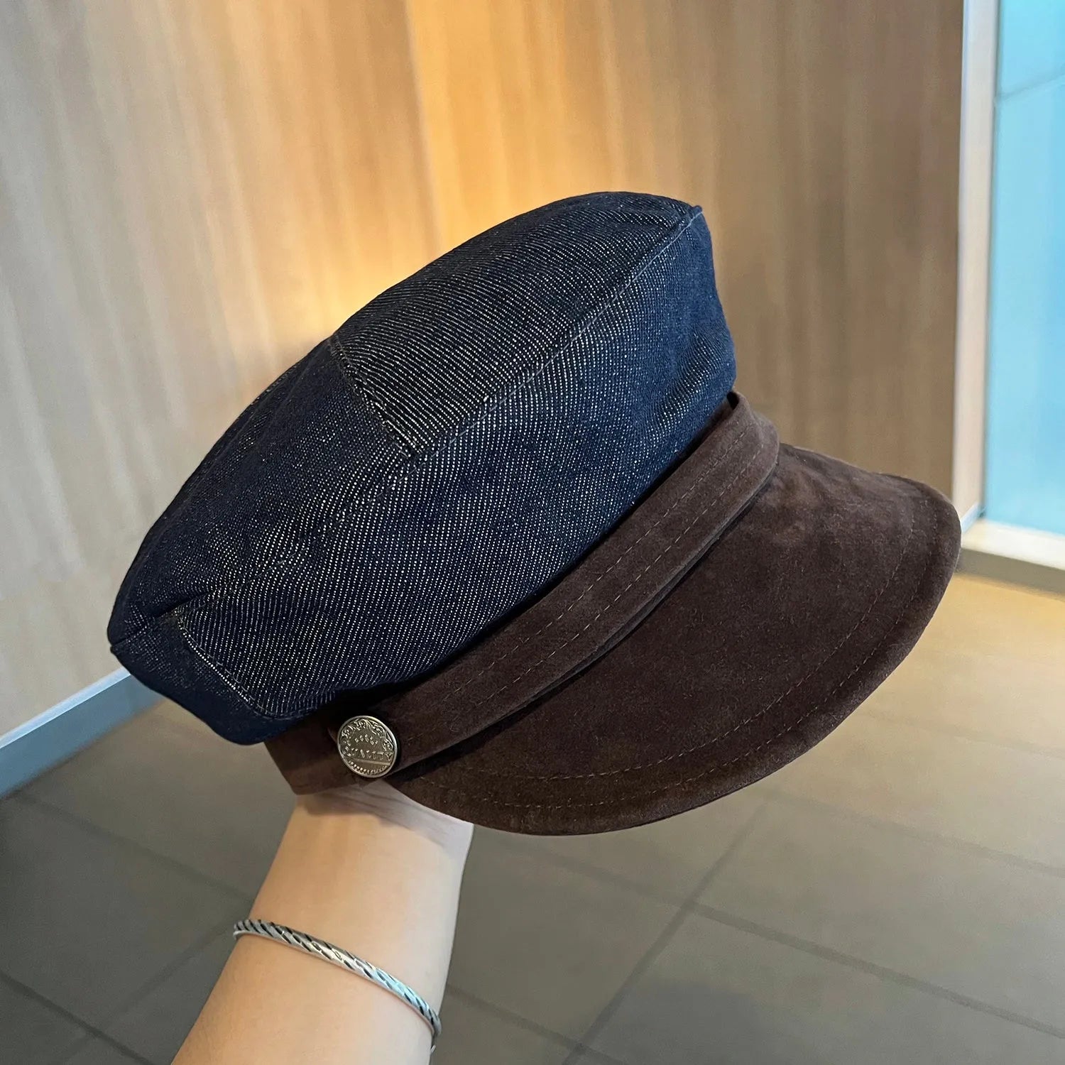 Dark blue denim octagonal newsboy hat with adjustable band and colour trim brim options