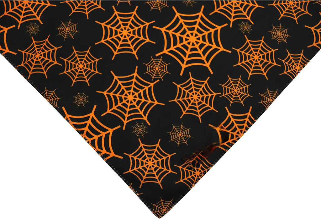 Reversible Halloween dog bandana with pumpkin and spider web designs in black and orange colours