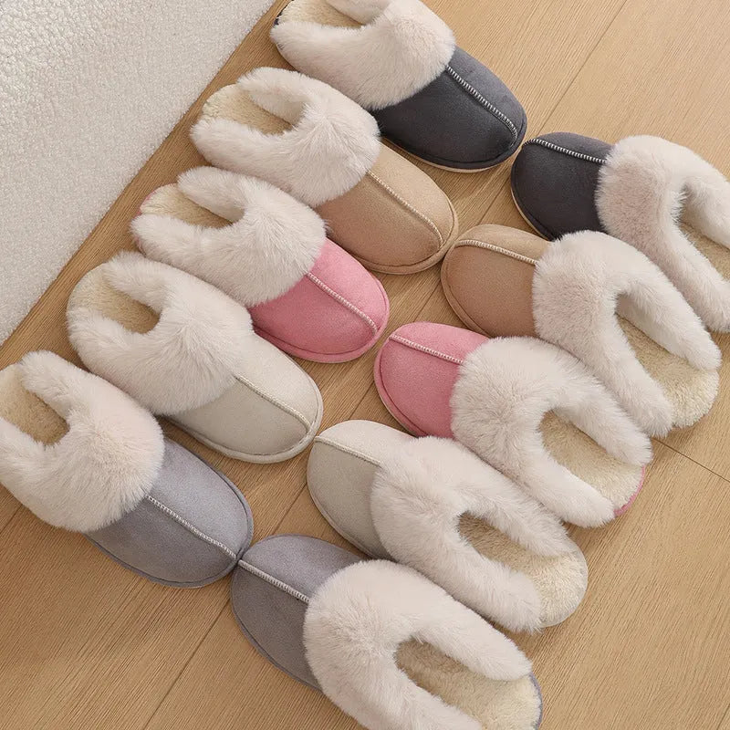Brown plush indoor slippers with round toe, decorative stitching, and a light-coloured anti-slip sole.