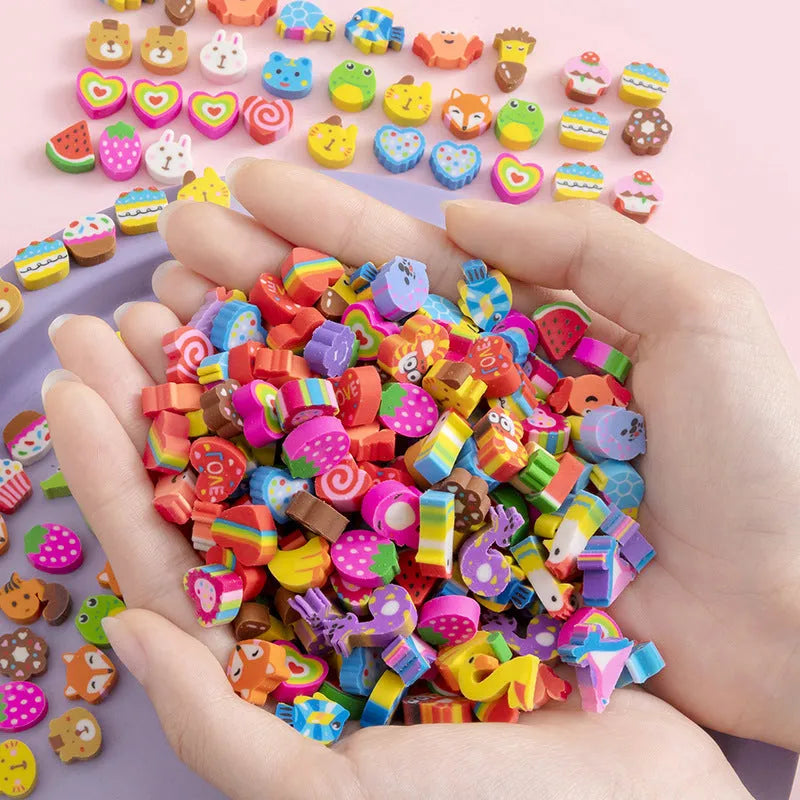 Assortment of fifty small cartoon-shaped rubber erasers in fruit and animal designs.