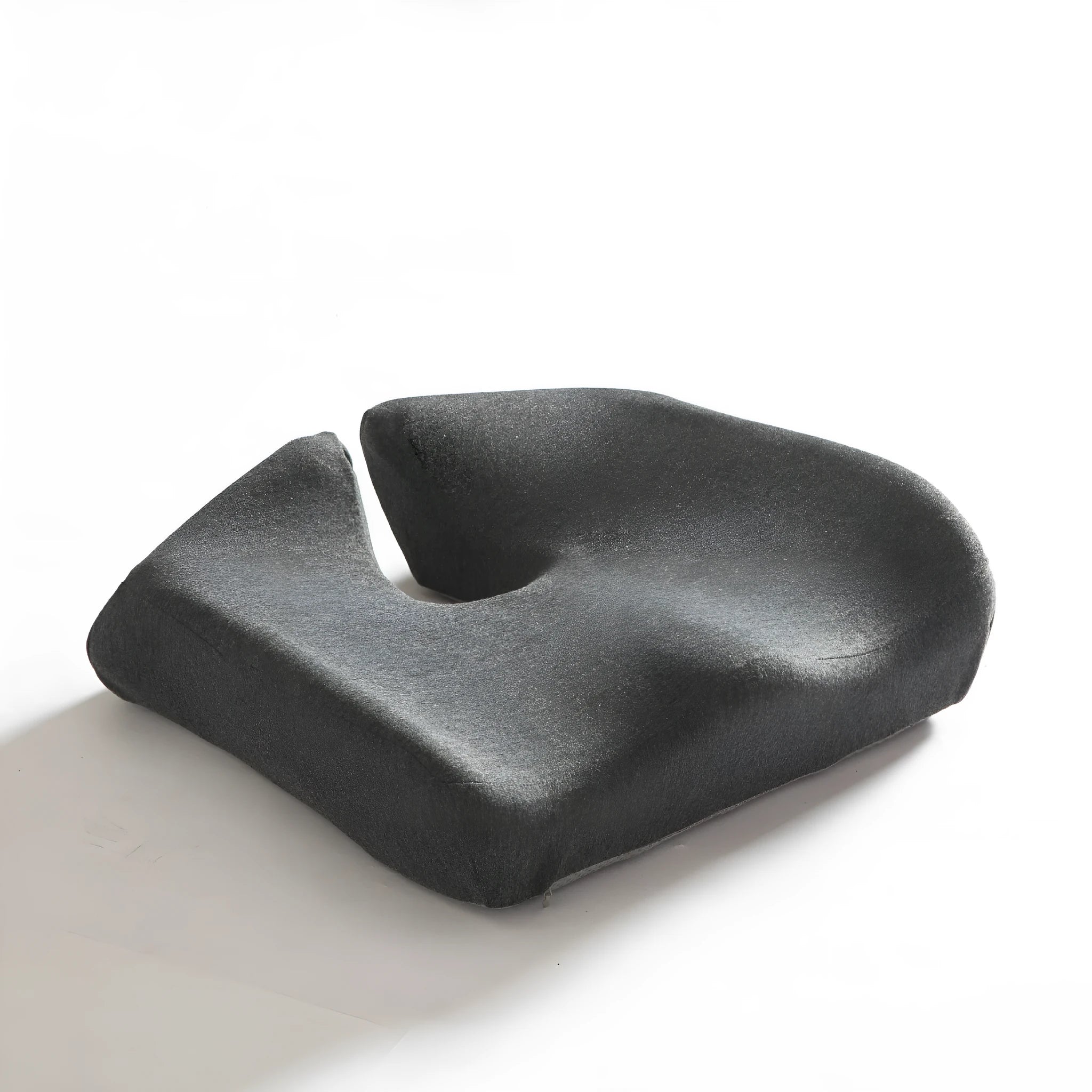 Dark grey memory foam office chair cushion with lumbar support, shown on a black desk chair.