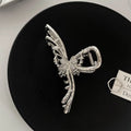 Electroplated silver metal hair barrettes in various designs including cross, wave, and bow shapes.