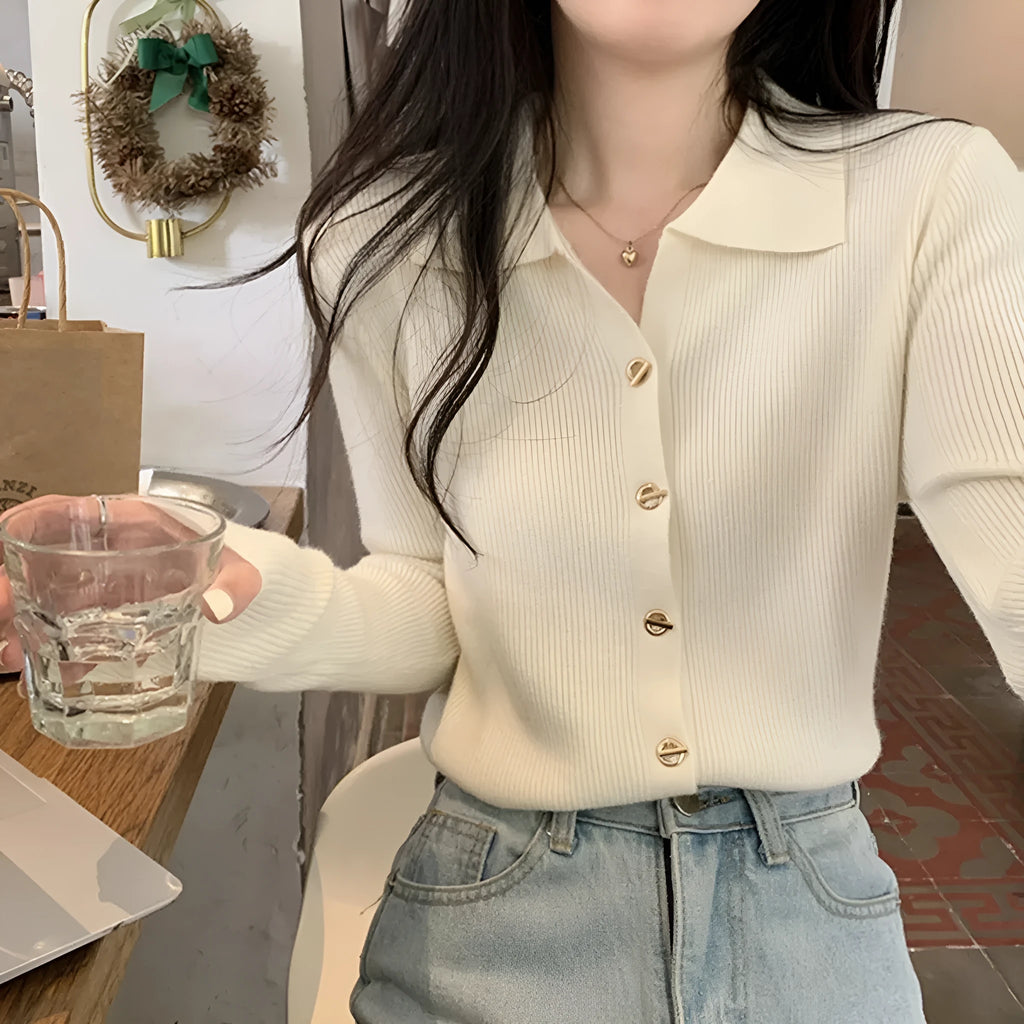 Beige loose fit long-sleeved viscose knitted cardigan top on a hanger.