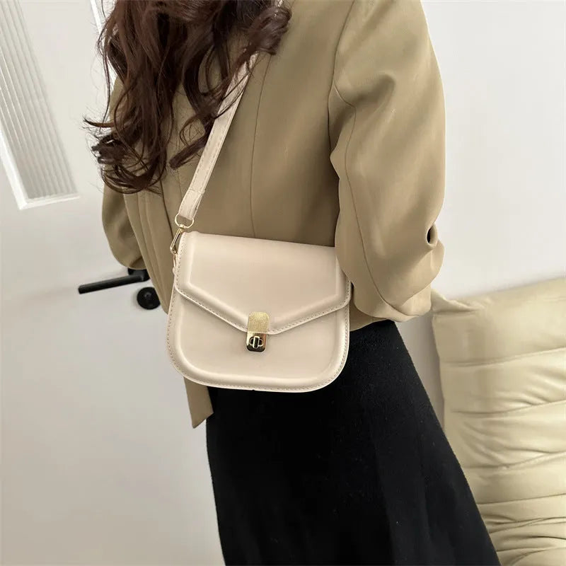 Soft black PU messenger bag with clamshell opening and niche texture, shown open.