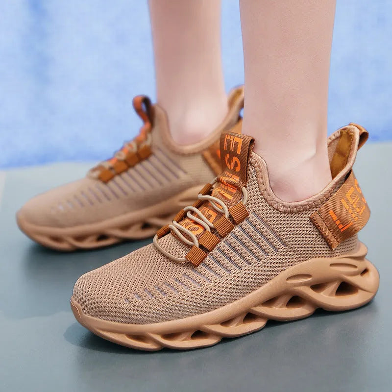 Kids coconut sneakers with Velcro closure in black, khaki, or white colours showing fabric upper and EVA sole