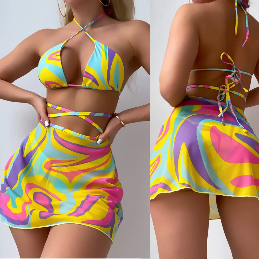 Yellow striped halter neck swimsuit with front lace-up detail, worn with matching skirt and shorts.