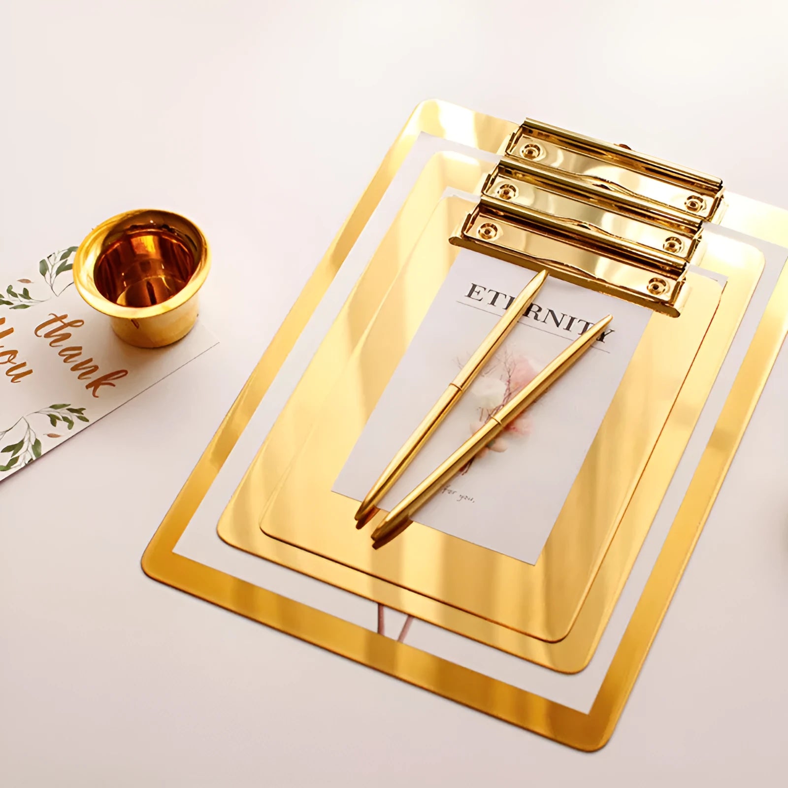 Stainless steel golden folder board in three sizes small, medium, and large on a white background