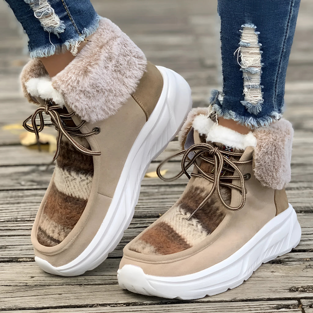 Women's beige lace-up snow boots with suede upper, thick rubber sole, and fuzzy lining on a white background.