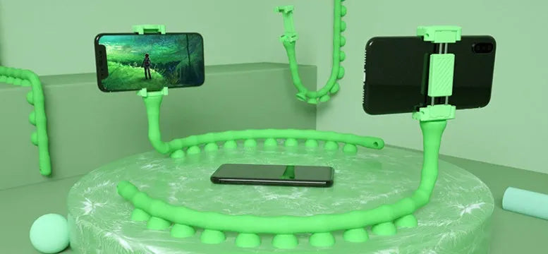 Flexible black rubber phone holder with suction cup wrapped around a bicycle handlebar, showing a phone mounted at an angle.