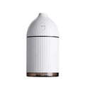White ultrasonic aromatherapy diffuser and humidifier with 300ml capacity, USB port, and LED light on a wooden surface.