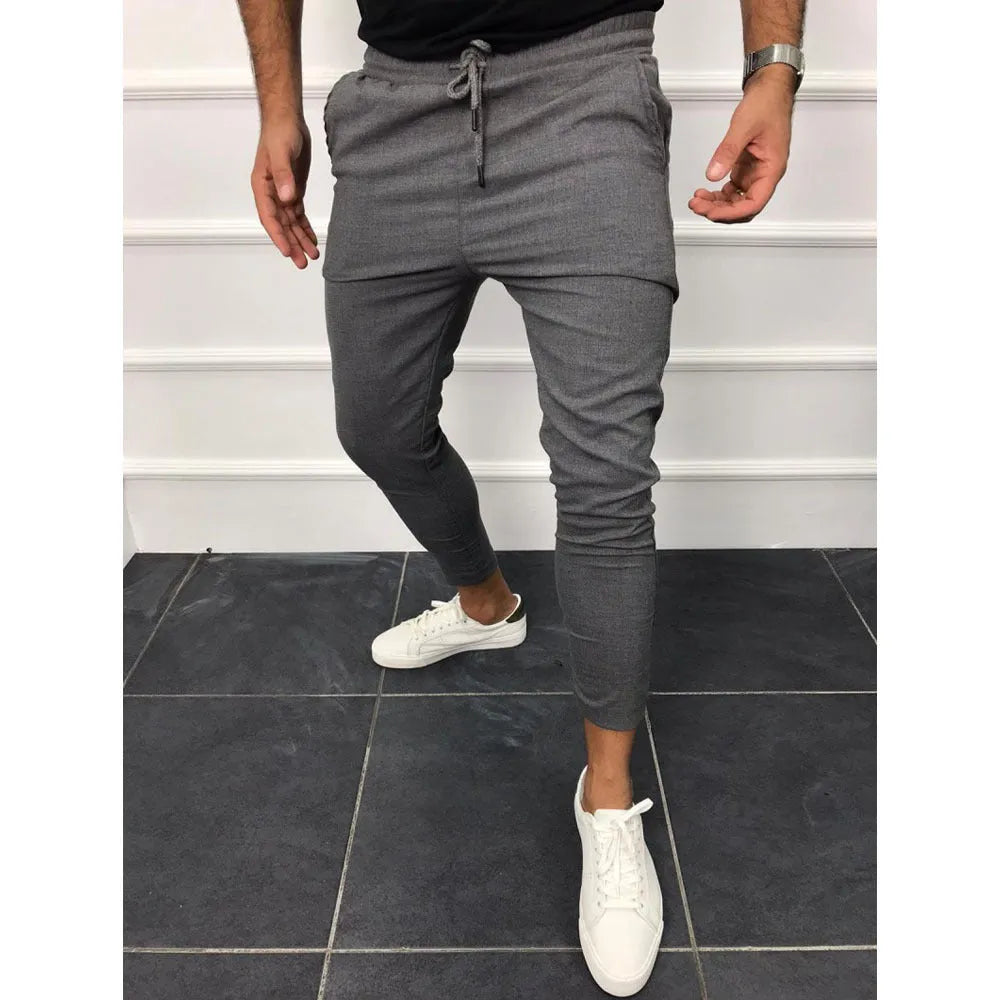 Lace-up casual jogging pants in solid light grey, nine points length, mid-waist, with adjustable front laces