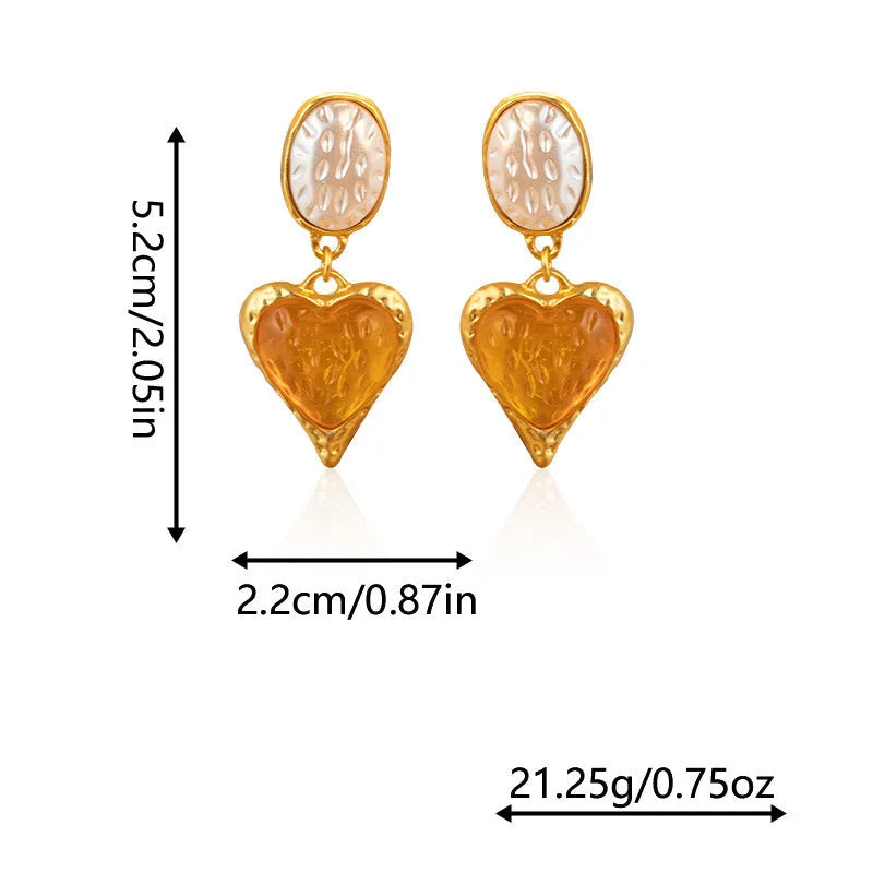 A pair of alloy pleated oval heart-shaped stud earrings with silver posts on a white background.