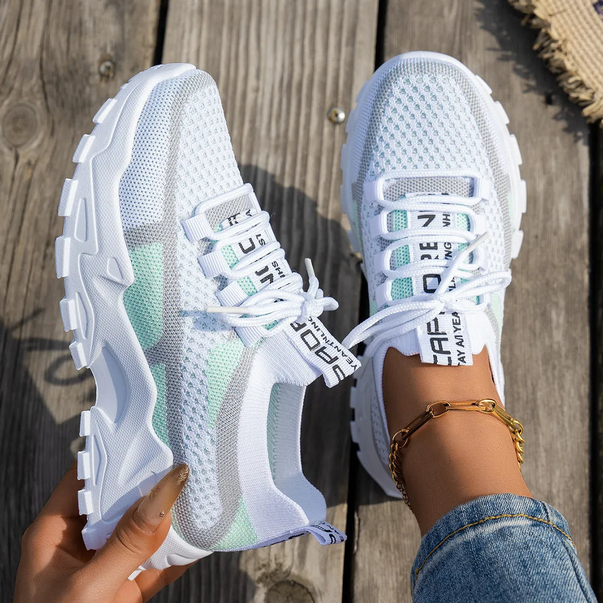 Women's Flyknit mesh lace-up sneakers in a selection of colours, showing round toe and flat rubber sole.