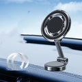 Black car phone holder with magnetic clip mount attached to a vehicle instrument panel
