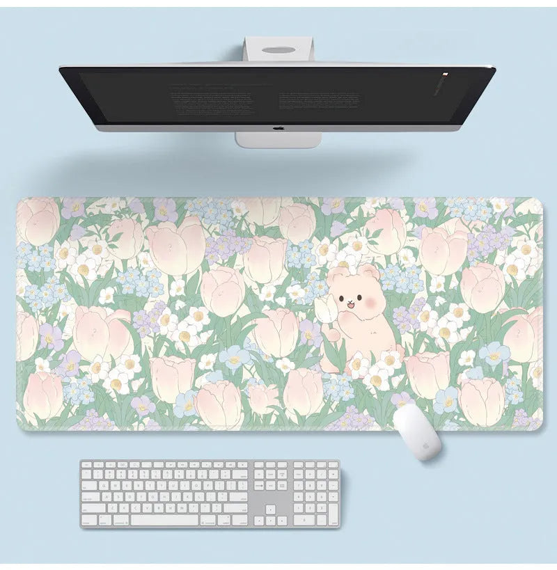 Large floral pattern mouse pad on a desk, showing non-slip rubber base and thin cloth surface.